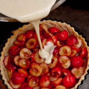 Pouring the custard into the cherry tart