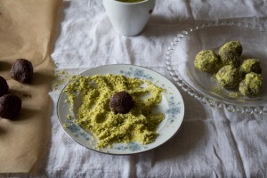 Rolling chocolate truffles in pistachios