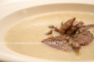 Jerusalem artichoke and leek soup topped with collar bacon