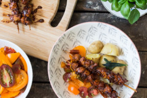 chicken skewers with potatoes and salad