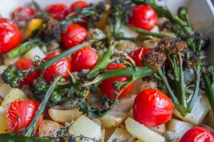Spring vegetable tray bake; a mix of different vegetables and potatoes with lemon, garlic and capers
